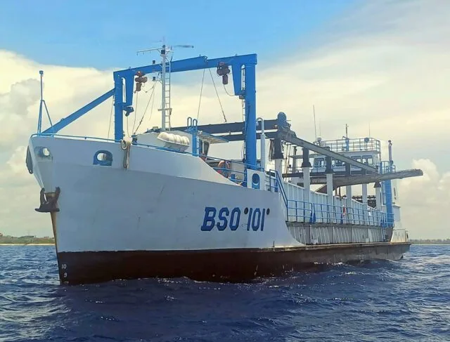 A large ship designed for sargassum collection at sea off the coast of Quintana Roo, Mexico.