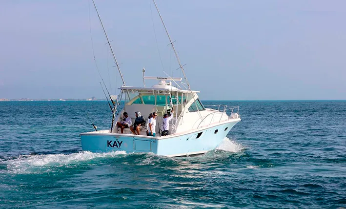 A sport fishing boat cruising in the turquoise waters of the Mexican Caribbean near Cancun