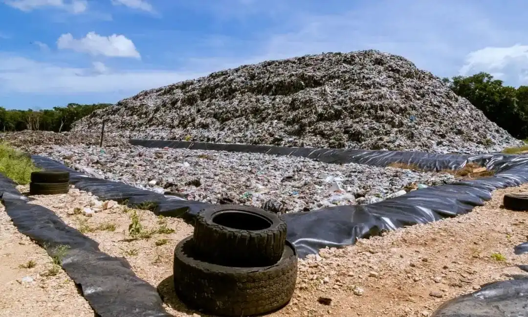 Aerial view of the closed Tulum landfill site with perimeter fencing and monitoring equipment