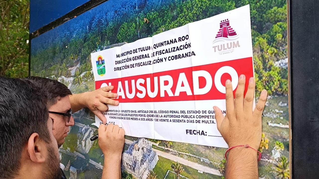 Municipal inspectors place closure seals on a booth at the north entrance of Jaguar Park in Tulum