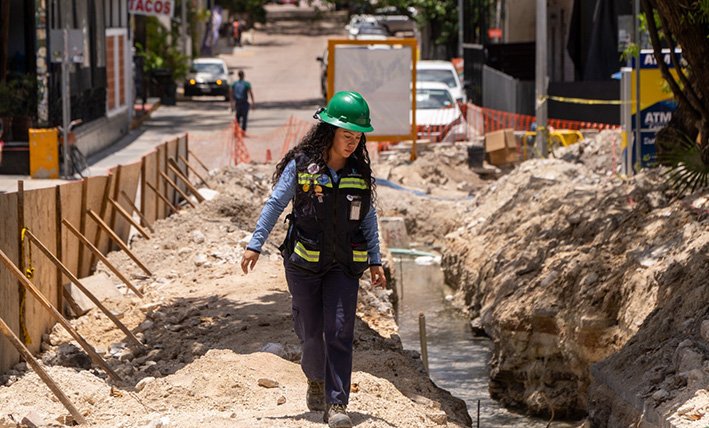Construction workers installing sewer pipe on a street in Playa del Carmen