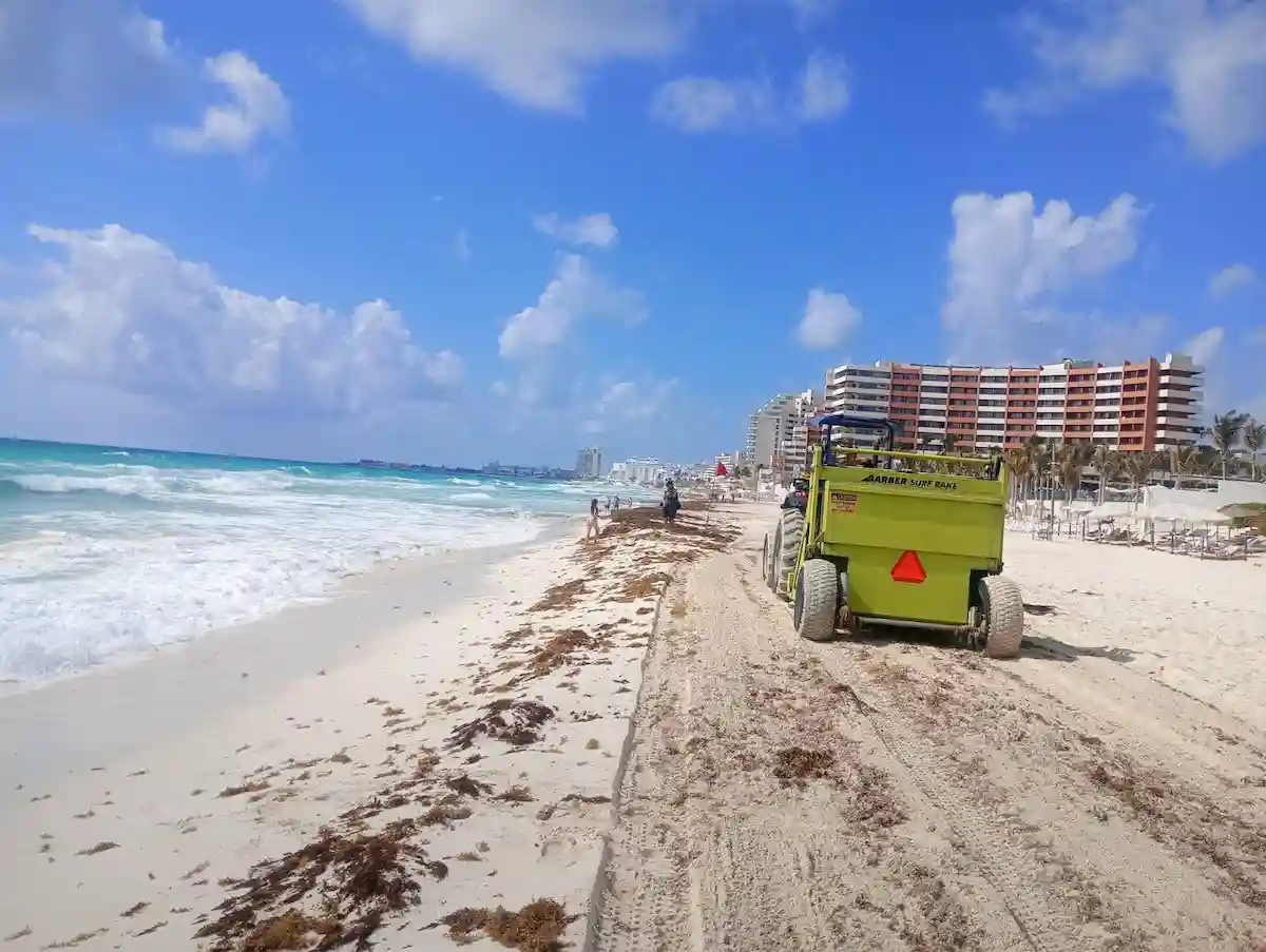 Aerial view of a beach in Cancun showing signs of erosion with narrow sand strip and exposed rocks