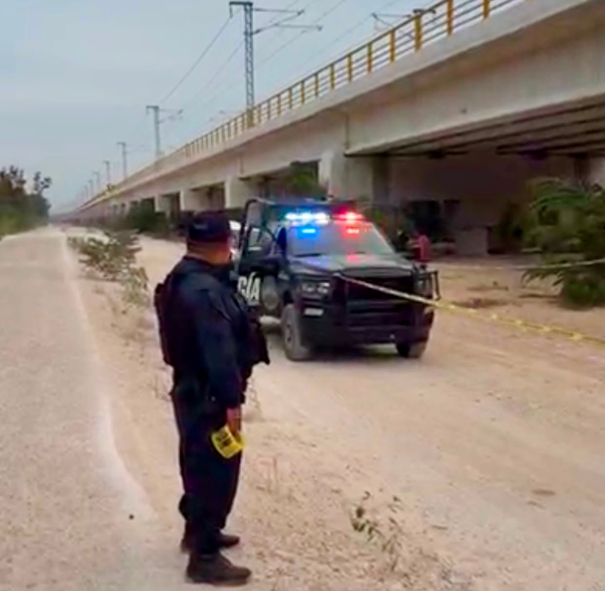 Crime scene tape cordoning off area under Maya Train bridge in Playa del Carmen