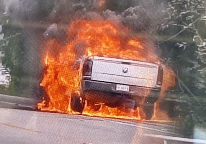A white Dodge truck completely burned out on the side of the El Tintal highway near Playa del Carmen