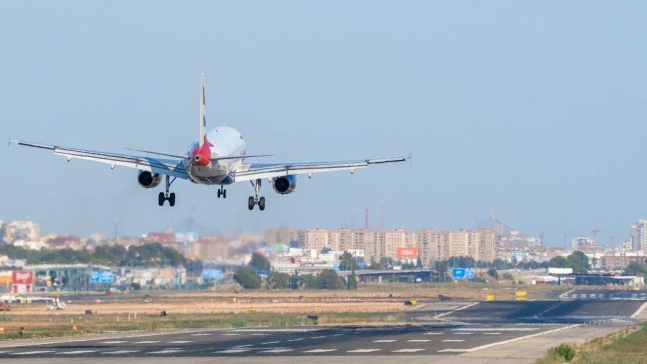 Cancun International Airport terminal with airplanes parked on the tarmac under a clear sky
