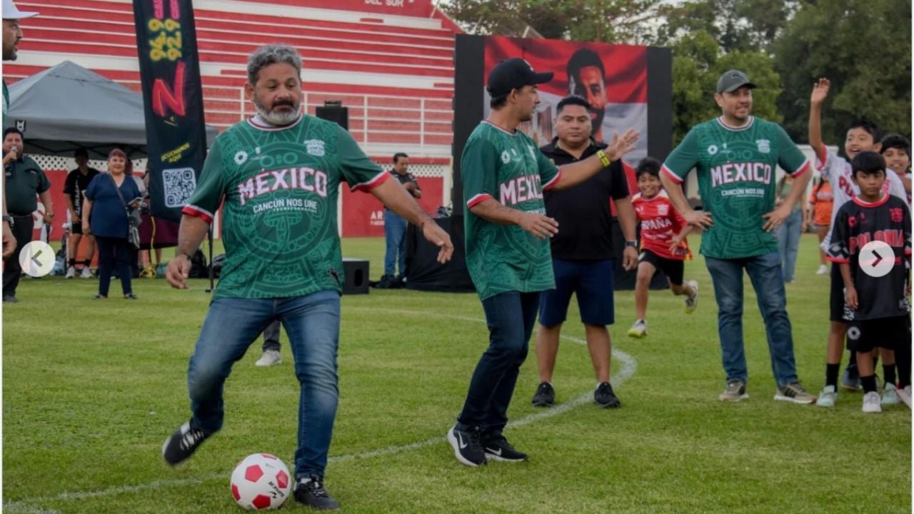 Crowd watching a football match on a large screen at an outdoor festival in Cancun