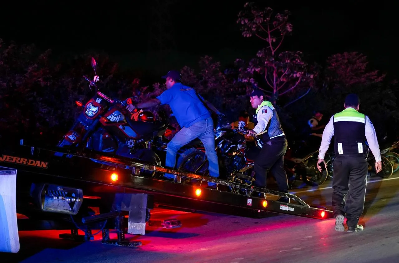Police officers at the scene of a motorcycle gathering operation in Cancun