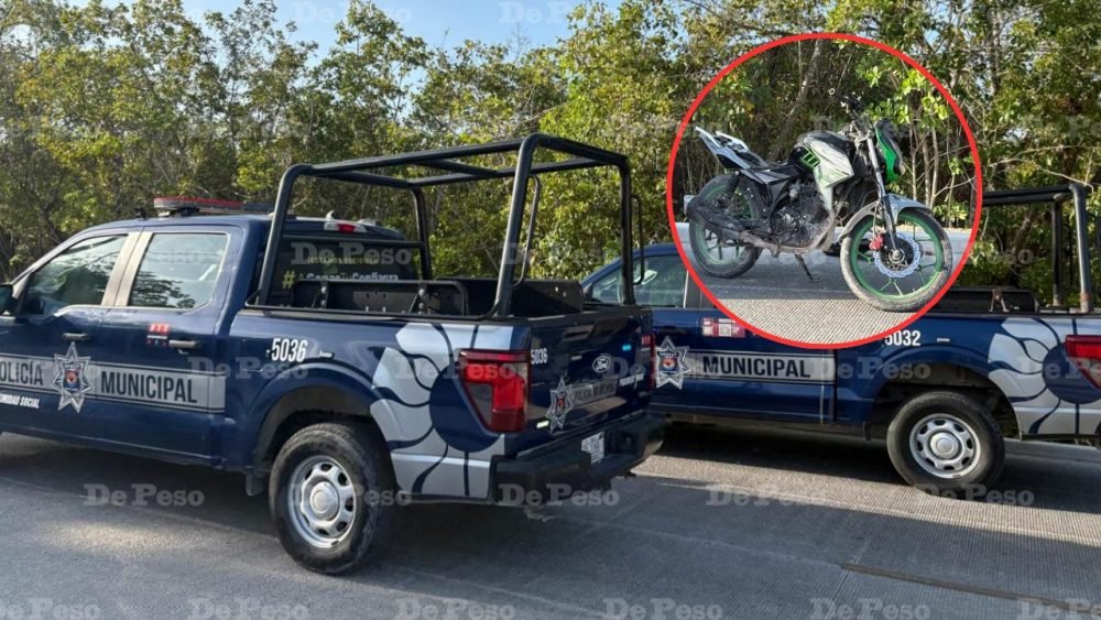 A man lies on the ground next to a motorcycle after being subdued by residents in Cancun.