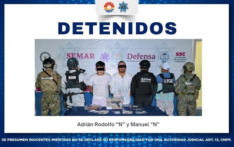 Police officers at a security operation in Cancun with seized weapons and drugs displayed on a table