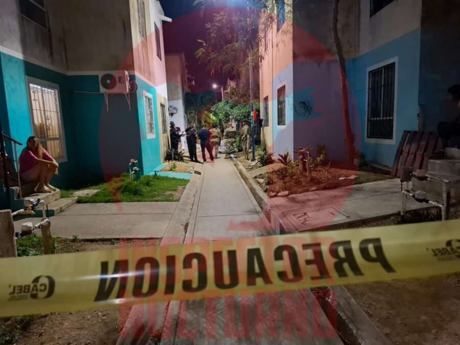 Crime scene tape at a residential building in Cancun after a fatal shooting