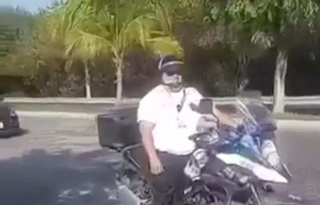 A Cancun traffic officer on a motorcycle patrol in Puerto Juarez