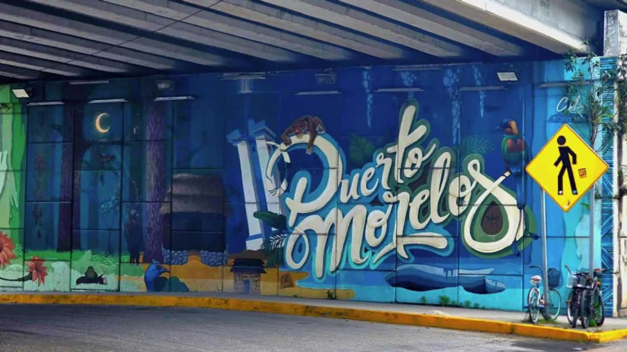 Vibrant murals painted on building facades in Puerto Morelos, Quintana Roo