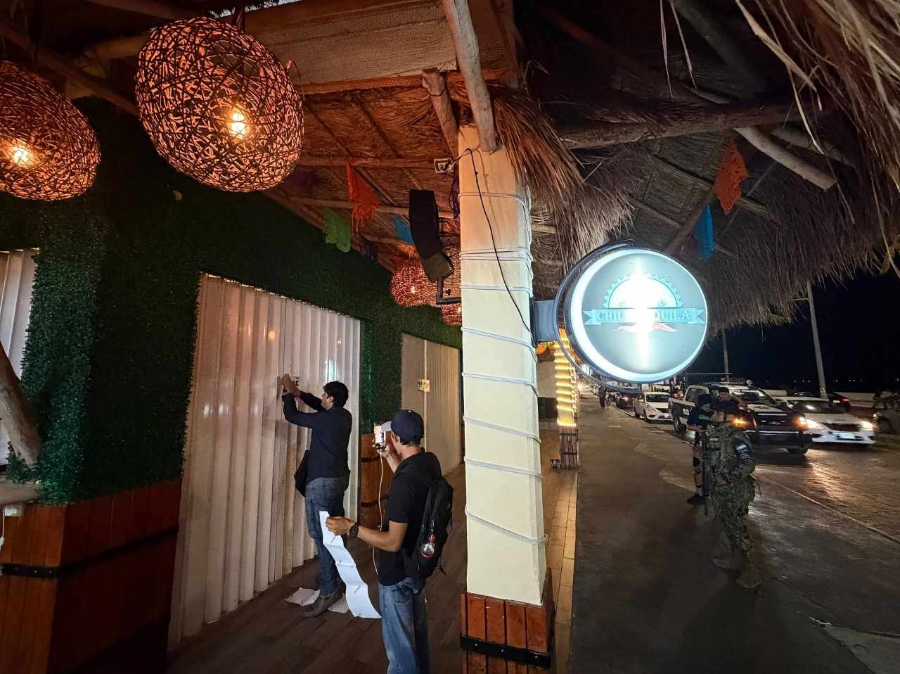 A restaurant in Cozumel with a closure notice on its door after a violent brawl