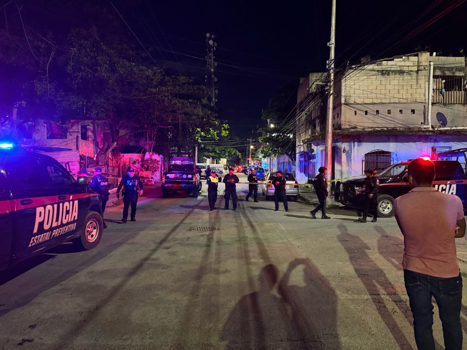 Police tape and officers at a crime scene in the Villas del Sol neighborhood of Playa del Carmen