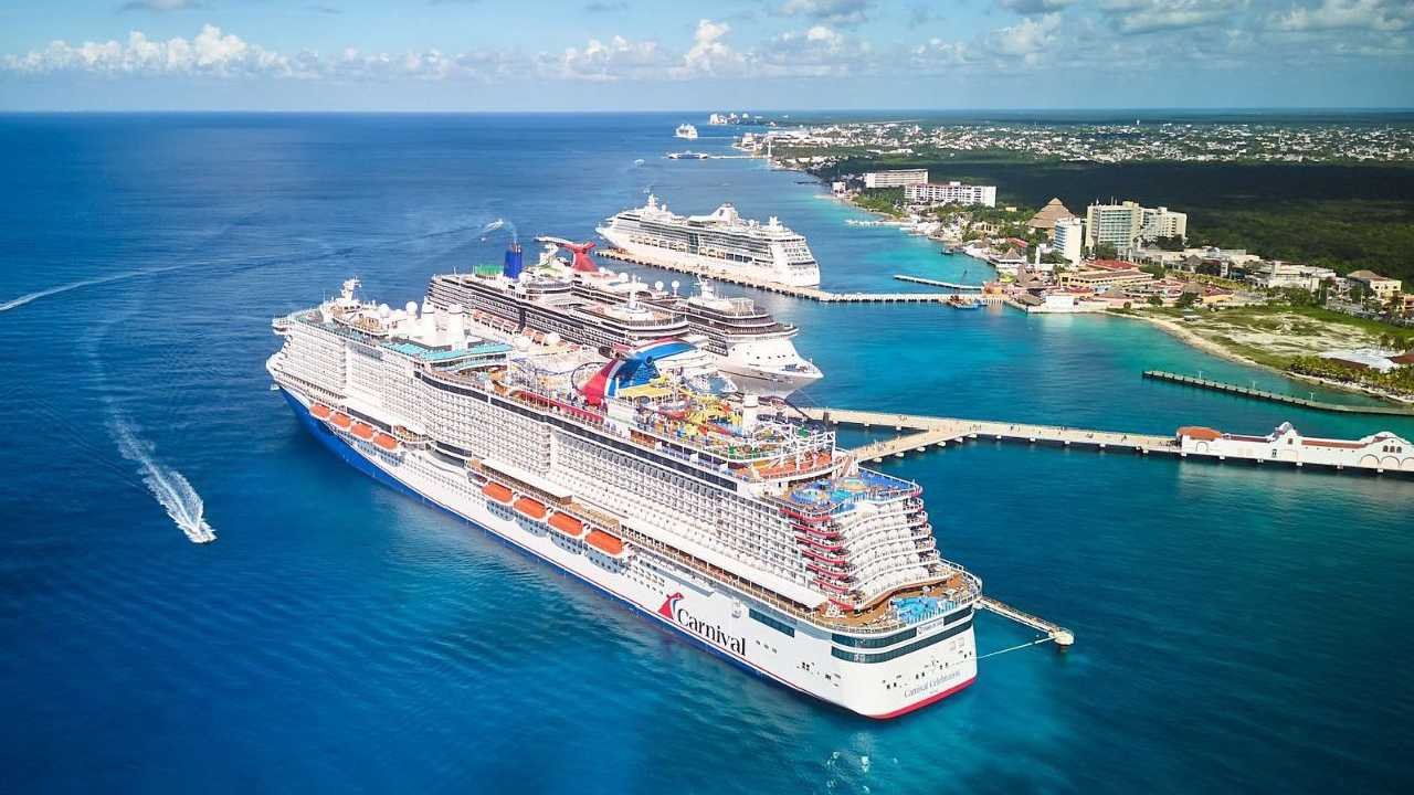 A cruise ship docked at the port of Cozumel, Quintana Roo, with turquoise Caribbean waters in the background.