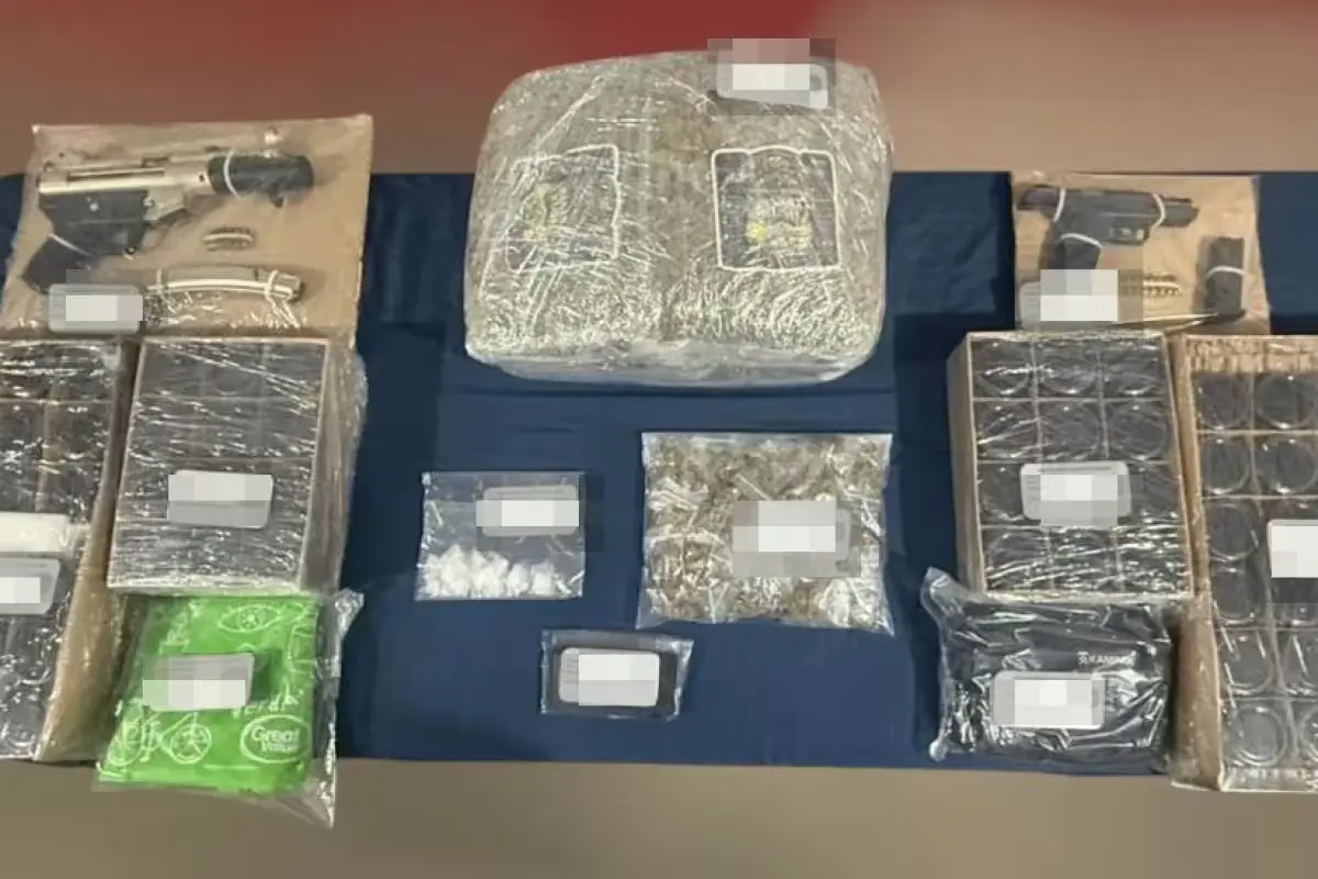 Police hold bags of marijuana and THC chocolates seized from a taxi driver in Cancun