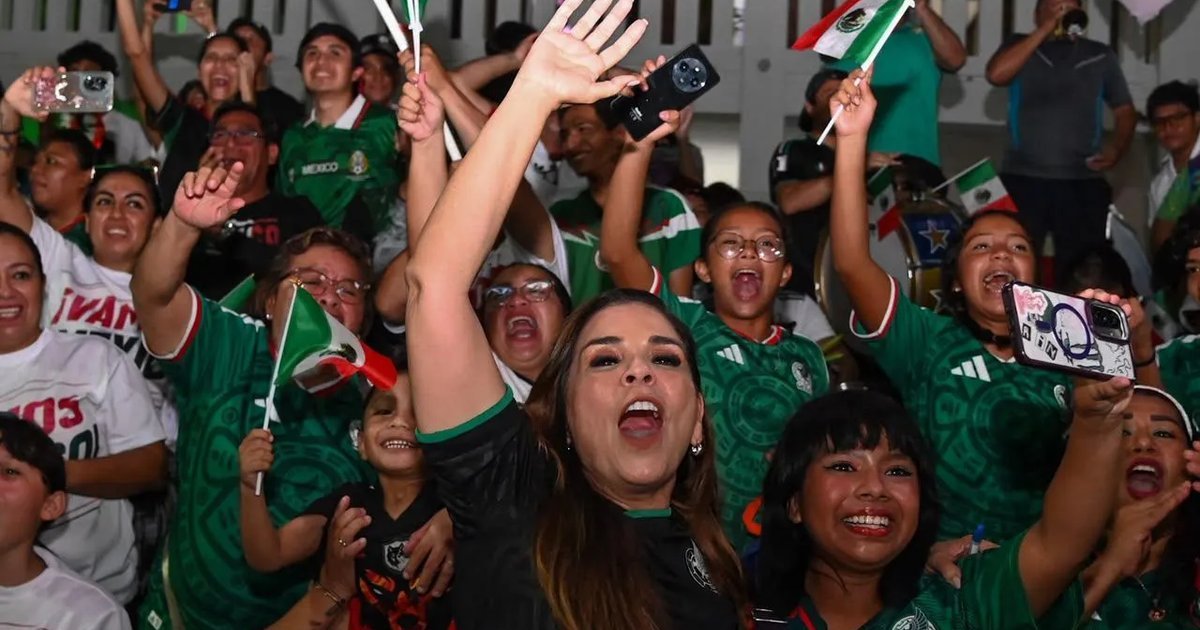 Crowd of families at Fut Fest in Chetumal, Quintana Roo, watching Mexico's World Cup match on a large screen