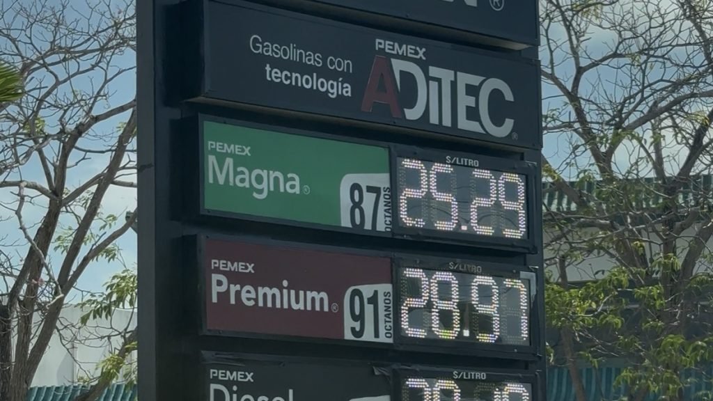 A gas station in Cancún displays a price of over 25 pesos per liter for regular gasoline.