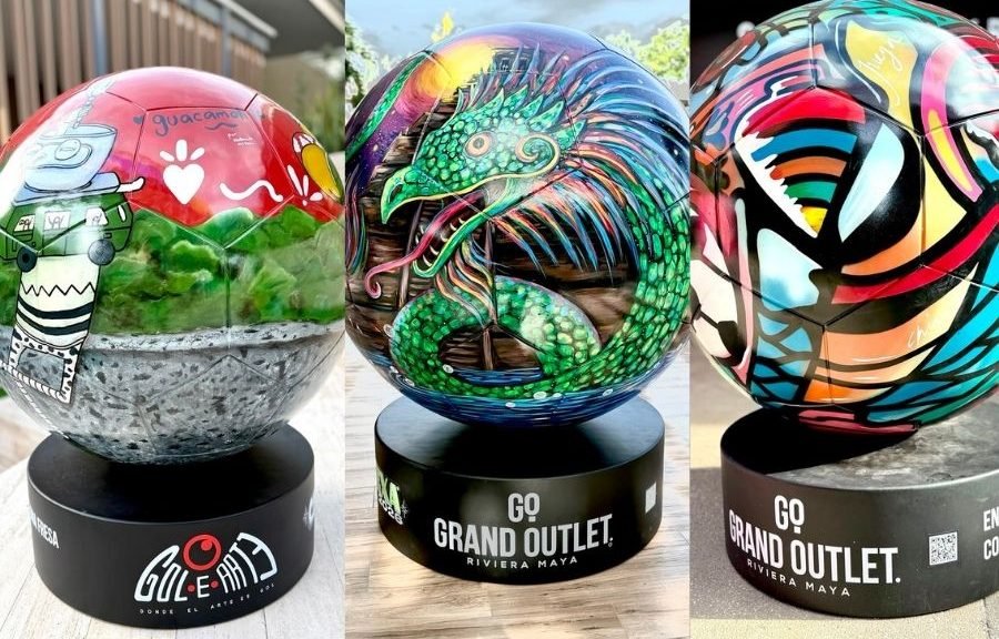 Colorful monumental soccer ball sculptures displayed outdoors at Grand Outlet Riviera Maya