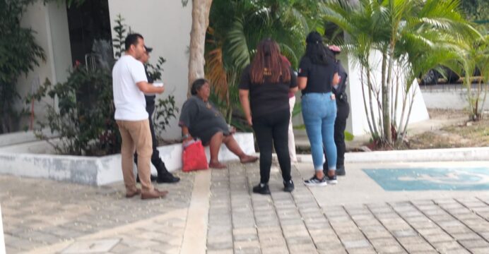 A homeless person sitting on a sidewalk in Playa del Carmen, Quintana Roo