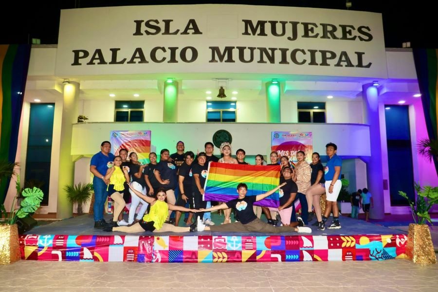 Colorful lights illuminate the facade of the municipal palace in Isla Mujeres during the Pride Month kickoff event.