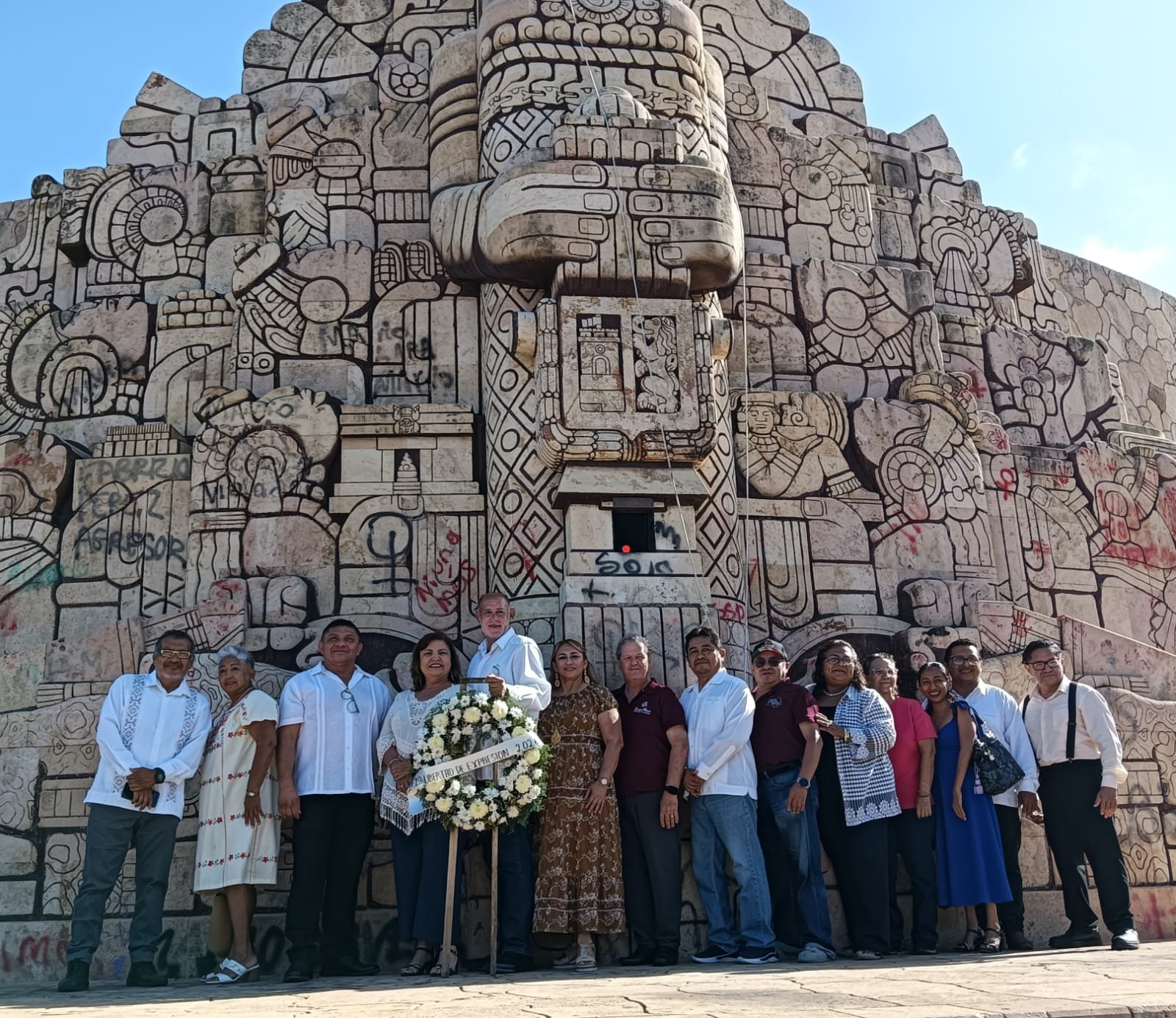 Group of journalists and communicators standing at Monumento a la Patria in Merida during a ceremony for Press Freedom Day