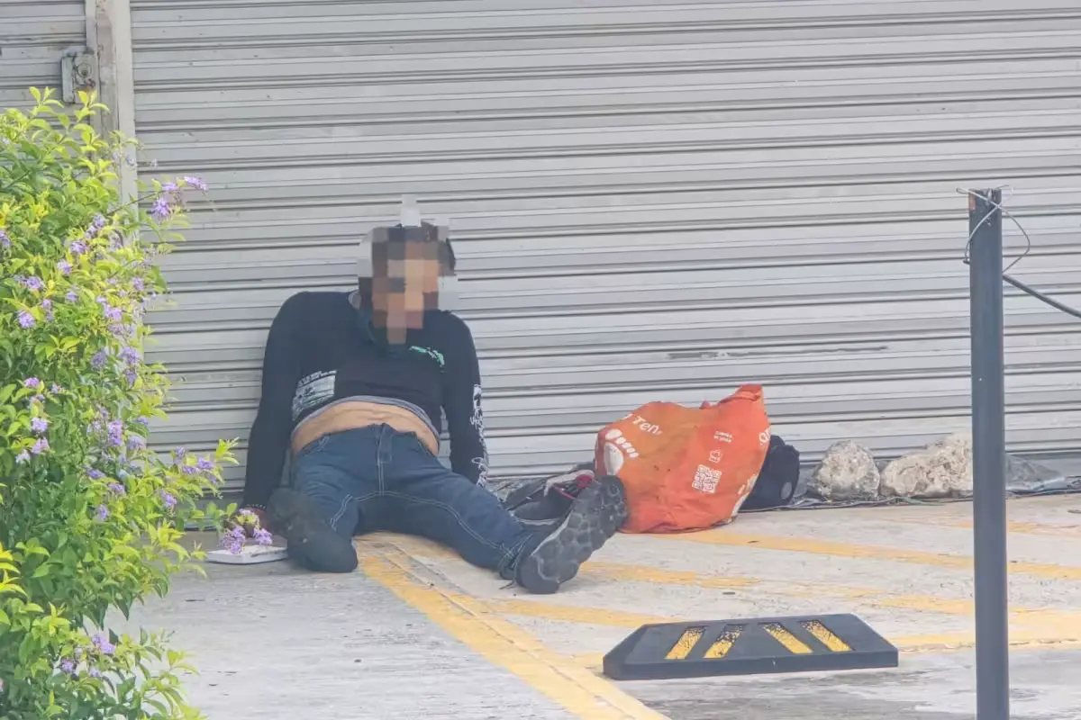 A man sitting outside a store near Playa del Carmen General Hospital, where he died after being denied medical attention.