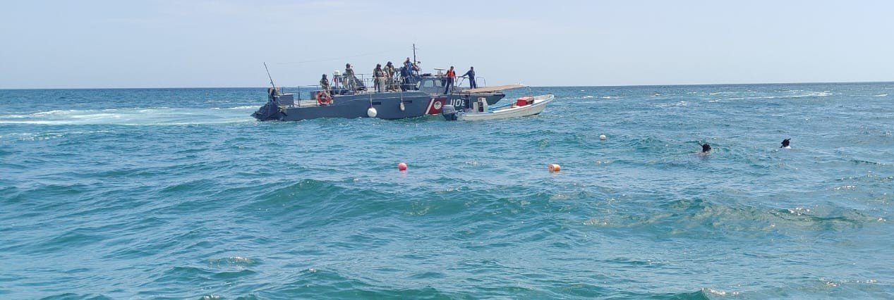 Mexican Navy personnel inspect seized sea cucumber and diving equipment on a boat off the coast of Yucatan