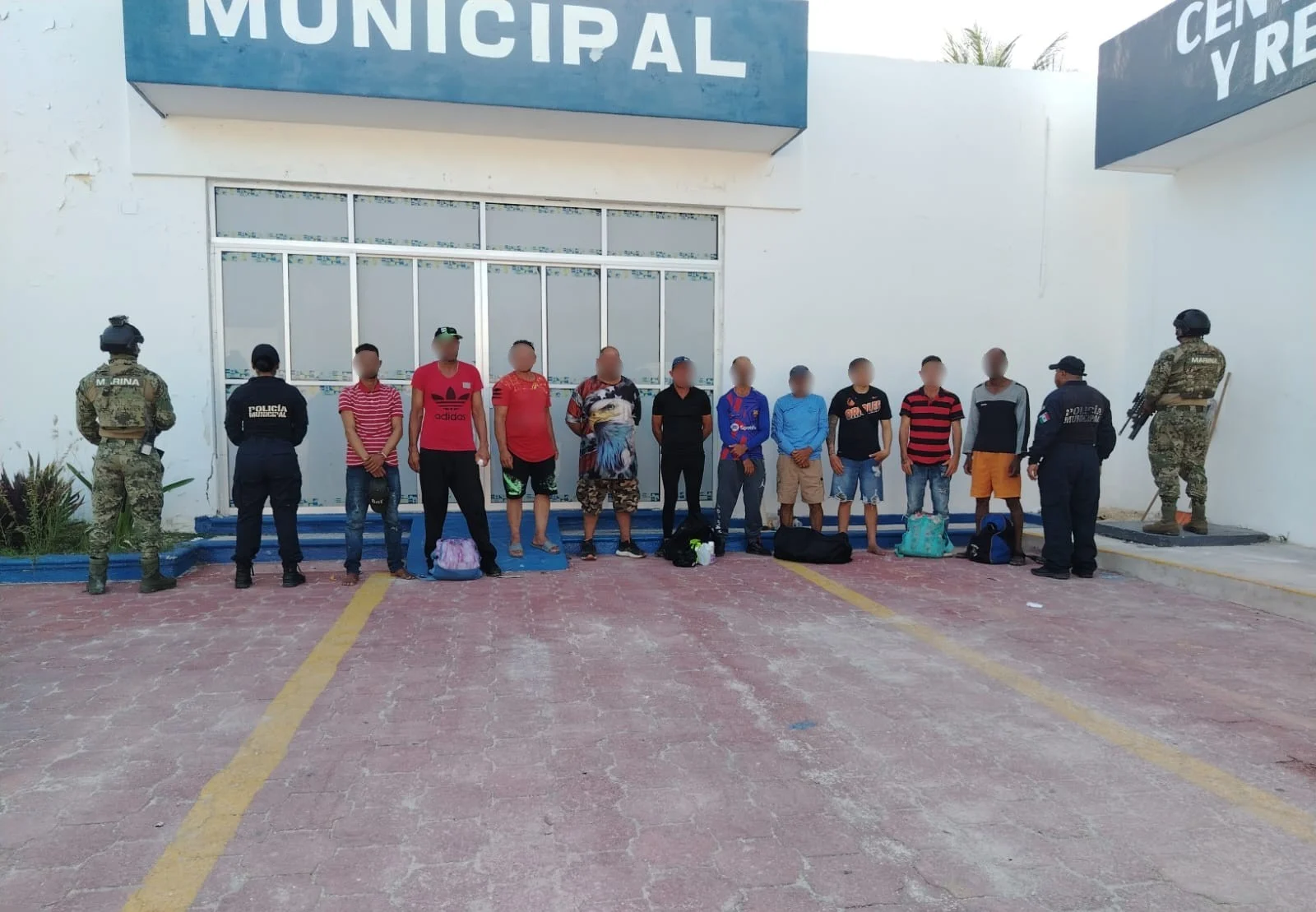 Mexican Navy personnel assisting Cuban migrants during transfer from Isla Mujeres