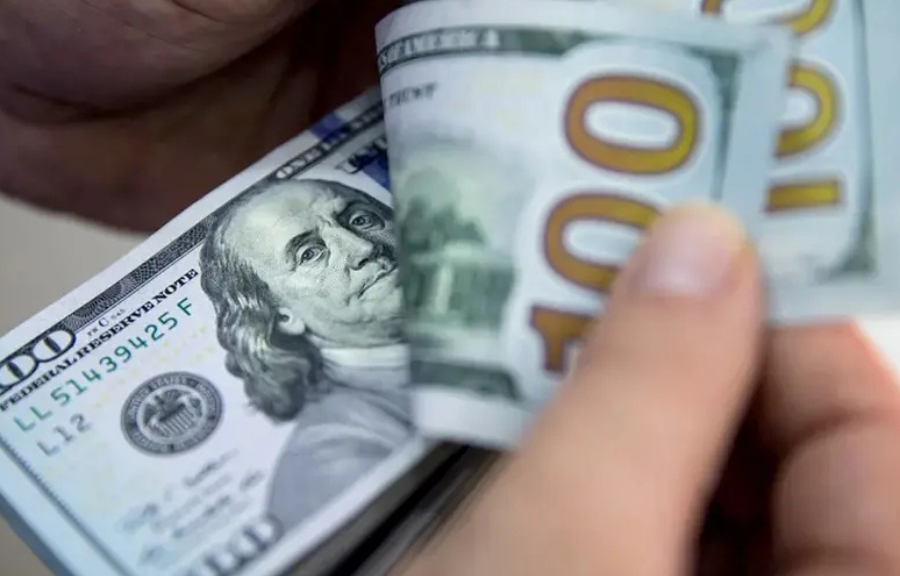 Mexican peso and US dollar banknotes on a table