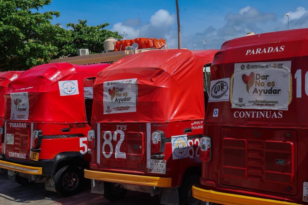 A mototaxi in Puerto Aventuras displays a decal for the 'Giving Is Not Helping' campaign against child labor.