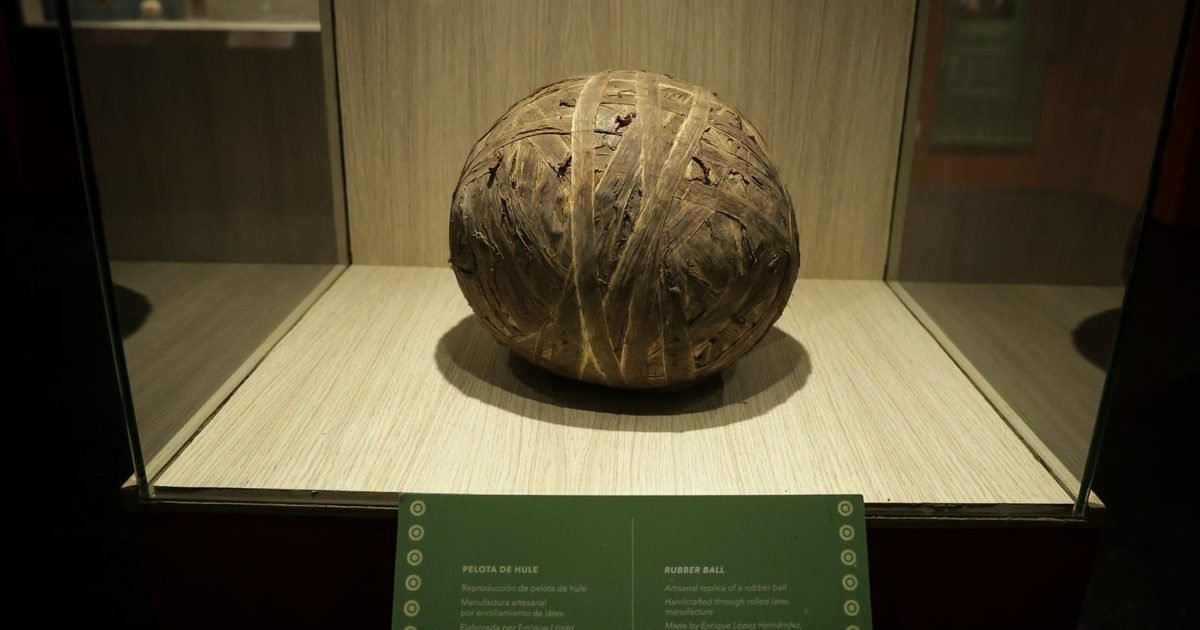 A 3,600-year-old Olmec rubber ball displayed in a climate-controlled case at the Museum of Teotihuacan Grandeur.