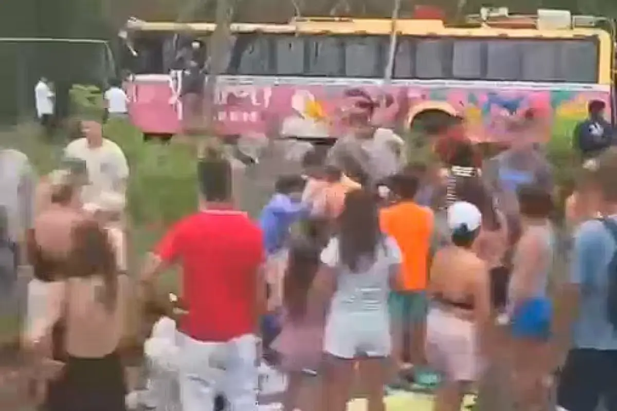 Passengers exiting a tourist bus that ran off the road near Chemuyil, Quintana Roo