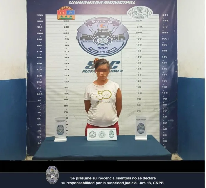 Police officers in Playa del Carmen detain a woman accused of attempting to sell a minor