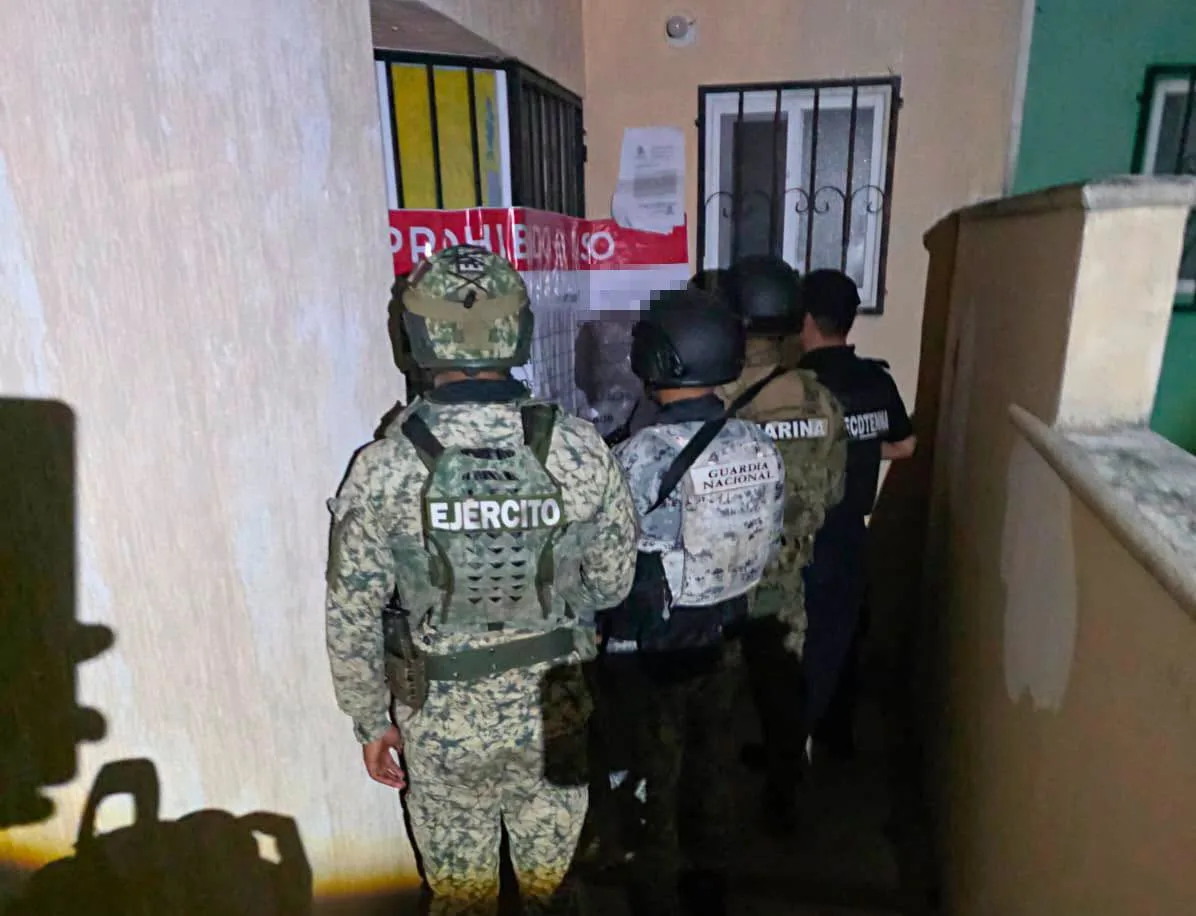 Police officers outside a building in Playa del Carmen during a raid