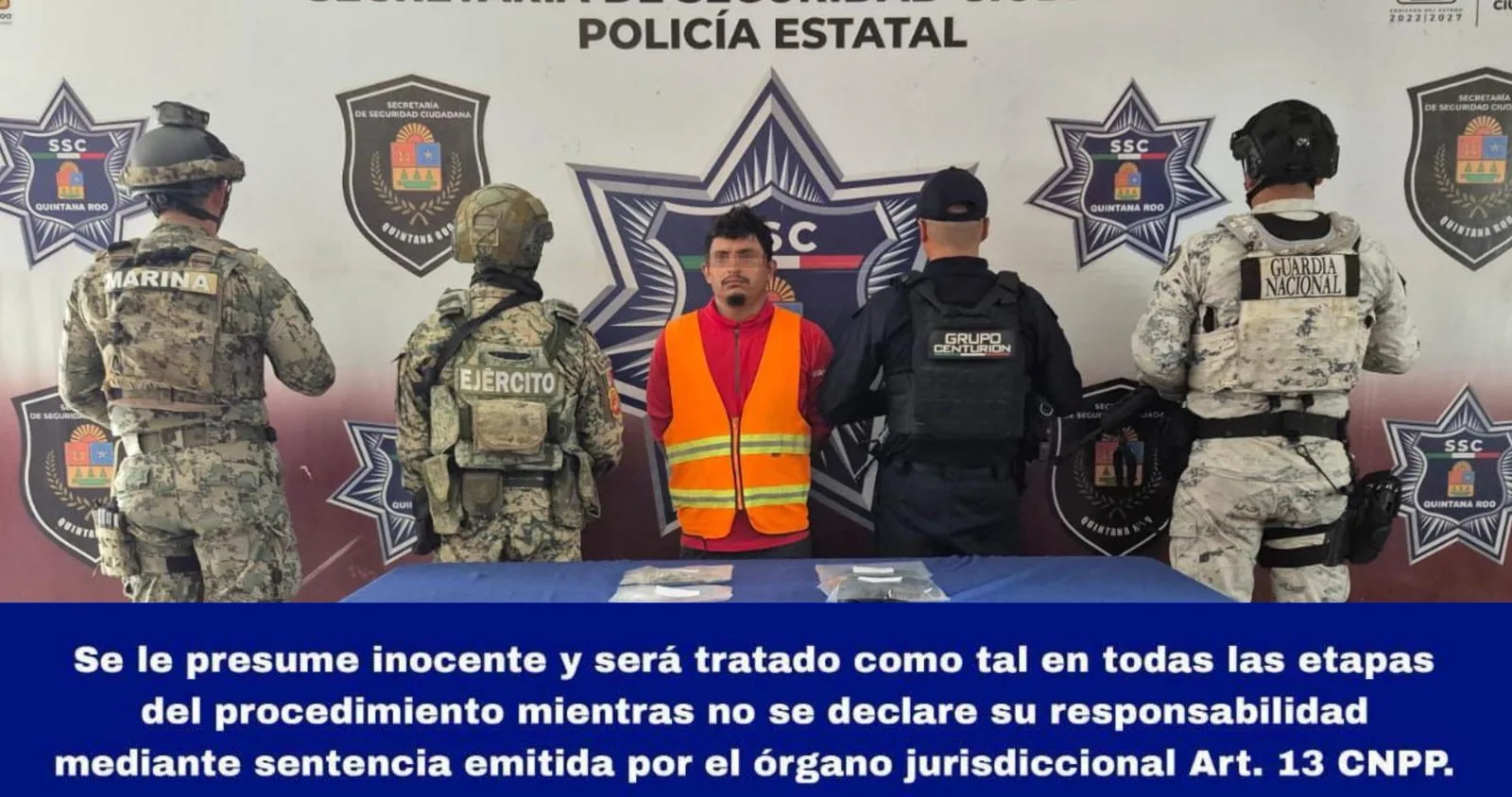 Police officers detain a suspect on a highway in Quintana Roo