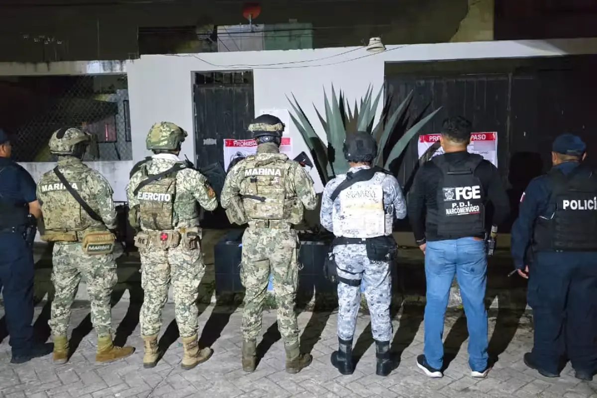 Uniformed officers from various agencies participate in a drug raid in Cancun