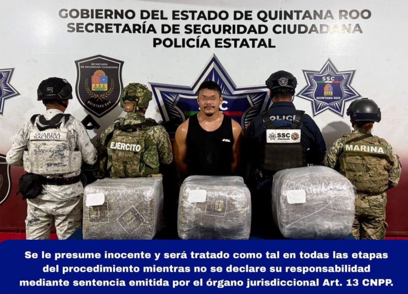 Police officers inspecting packages of marijuana seized during an arrest in Cancun