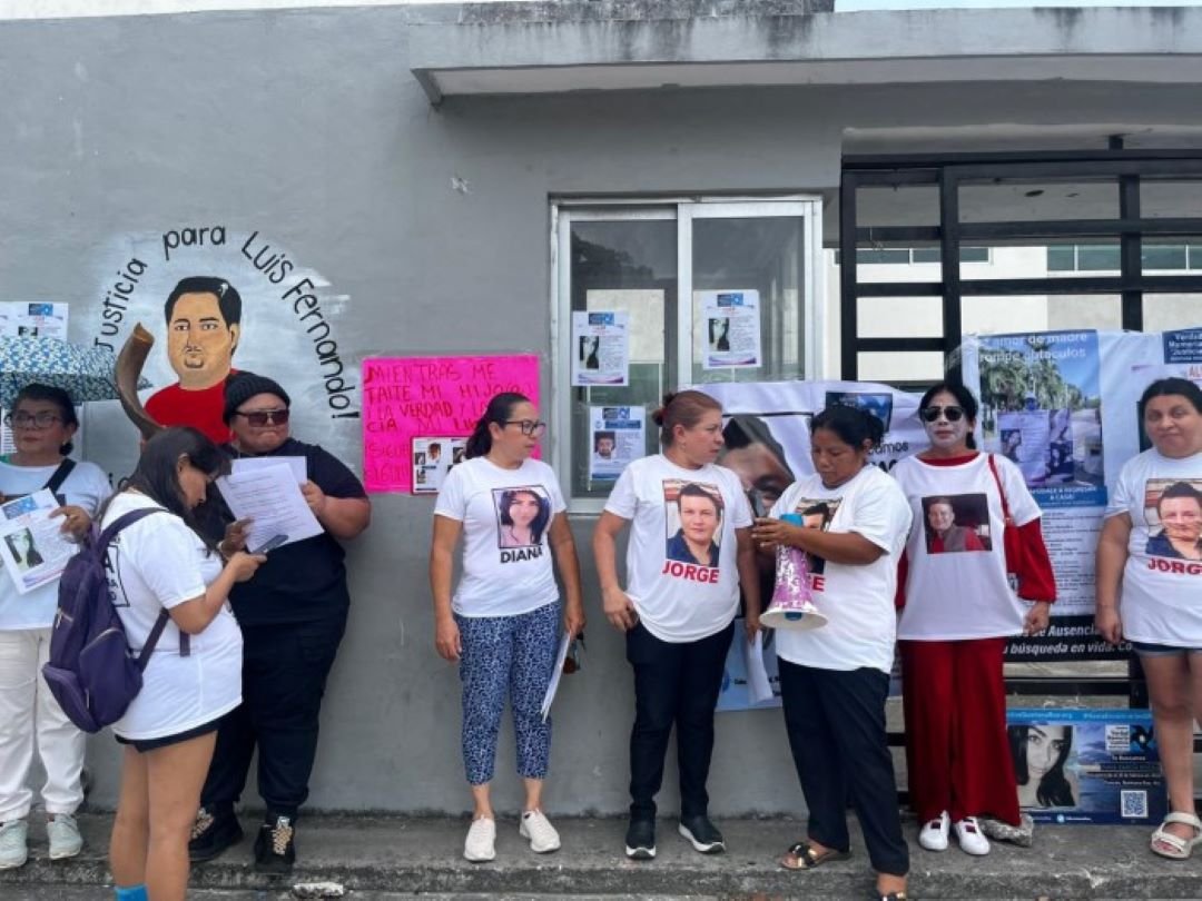 Activists protest outside the Oral Criminal Courts in Cancun ahead of the trial of a former police officer accused in the disappearance of two young people.