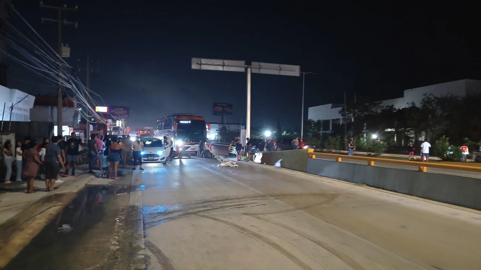Residents blocking a boulevard in Cancun with signs protesting police corruption