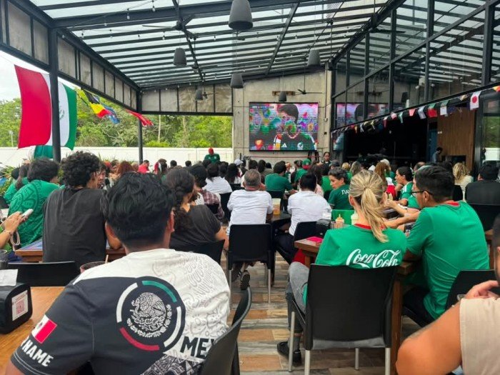 A restaurant in Cancun with a television screen displaying a World Cup football match