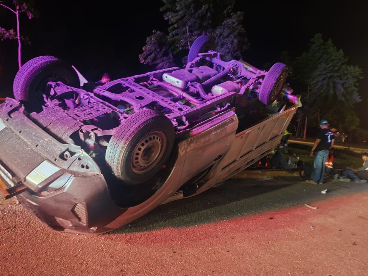 A rolled-over Nissan NP300 truck on the boulevard after a collision