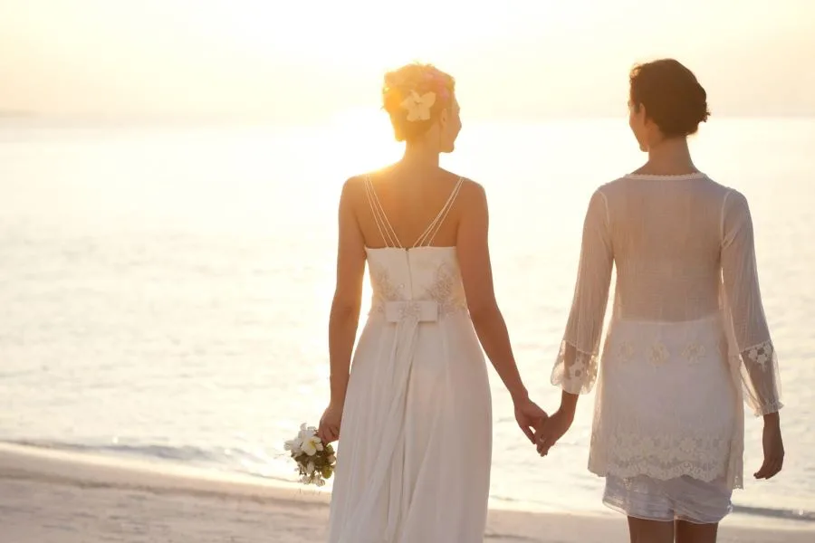 Two brides holding hands at a civil wedding ceremony in Chetumal