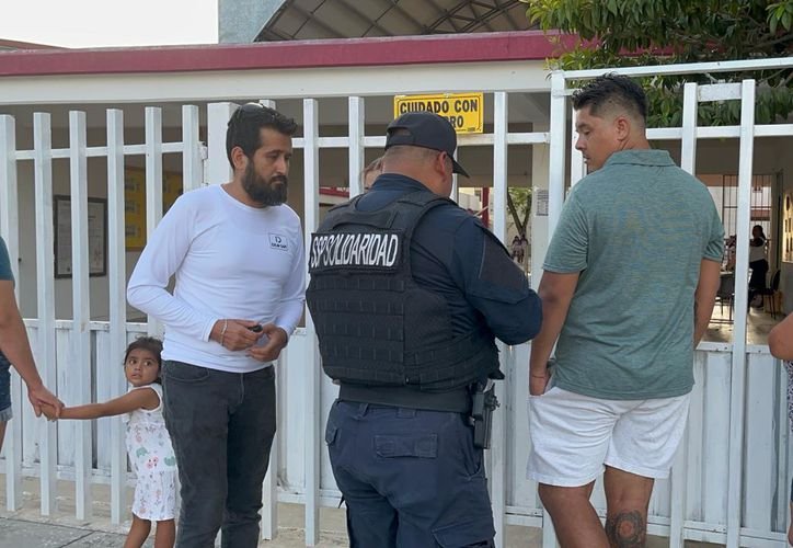Police officers inspecting a student's backpack at a school in Playa del Carmen