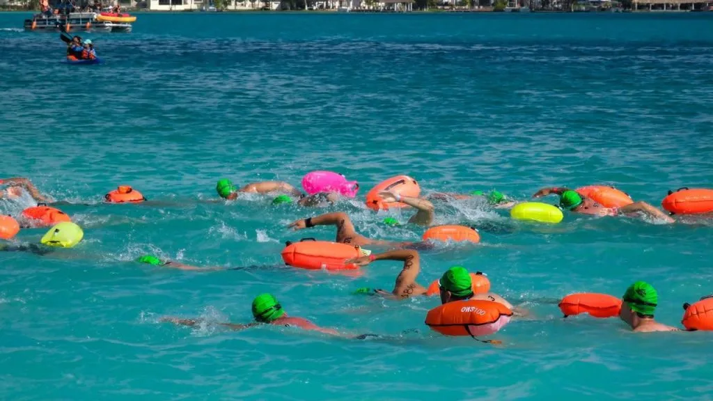 Swimmers competing in the Bacalar Open Water Marathon at the Laguna de los Siete Colores