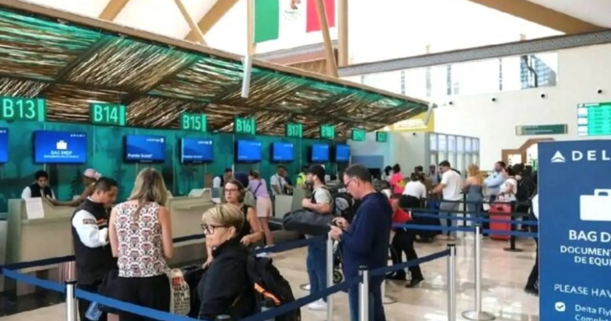 Travelers with luggage walking through Cancun International Airport