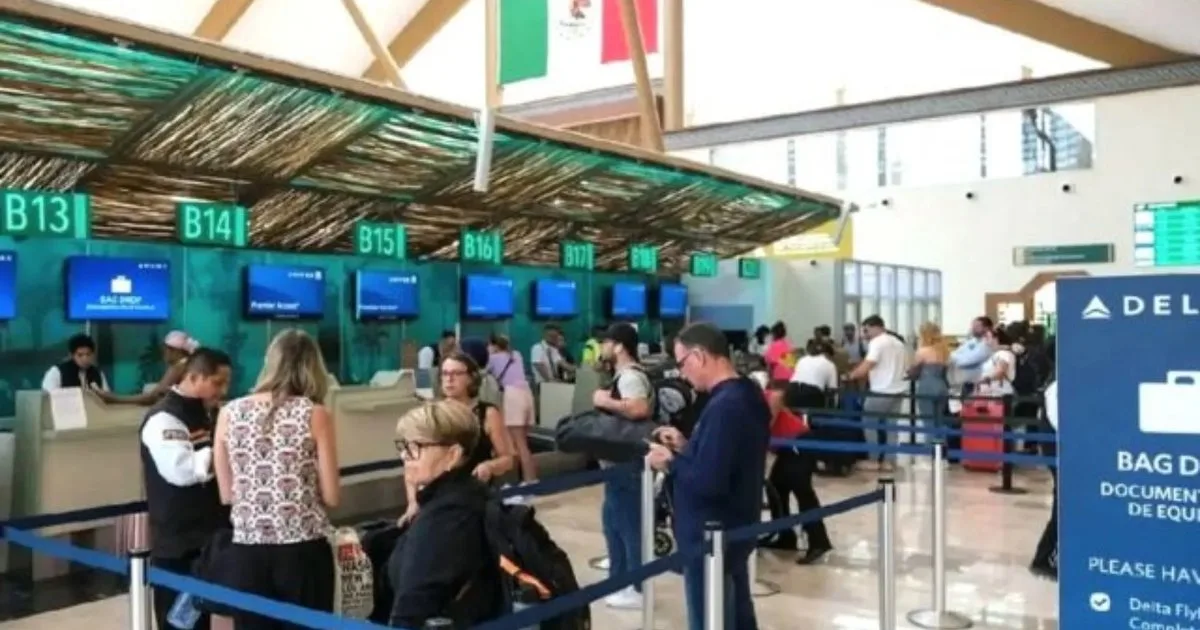 Travelers with luggage walking through Cancun International Airport