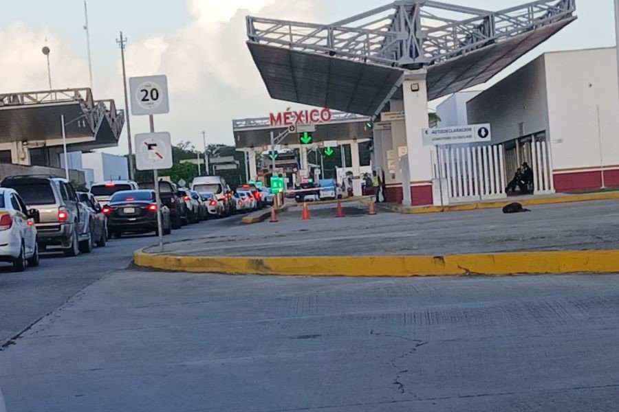 Long line of vehicles stuck in traffic at the Belize-Mexico border crossing near the Free Zone.