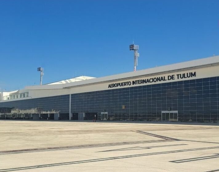 Exterior view of Tulum International Airport terminal with parked aircraft