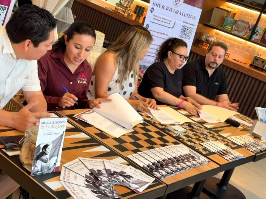 Officials and hotel representatives sign a training agreement in Tulum